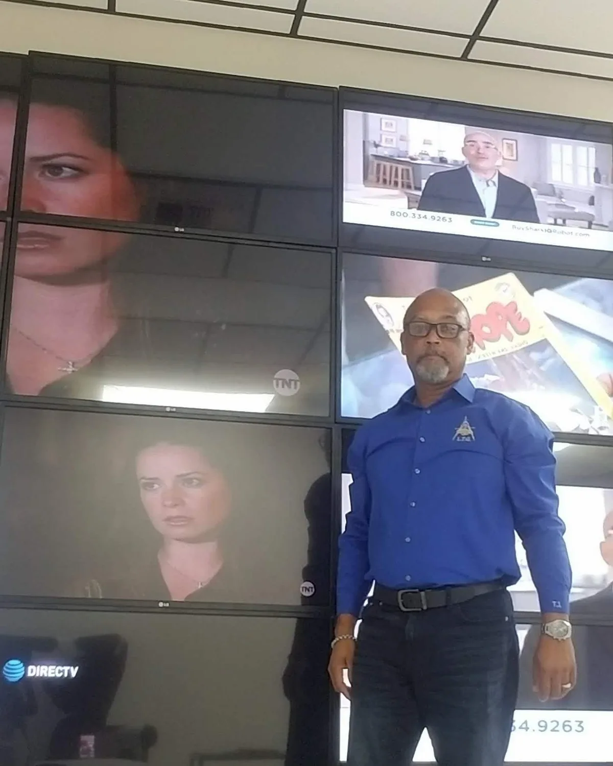 Thomas John Forestal in a Latserof shirt in front of a finished commercial video wall