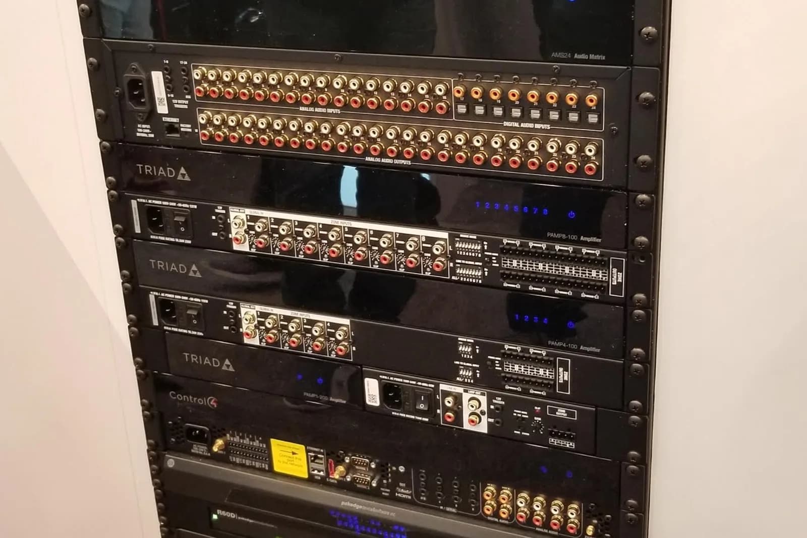 Equipment rack with labelled Triad amplification and Control4 automation hardware